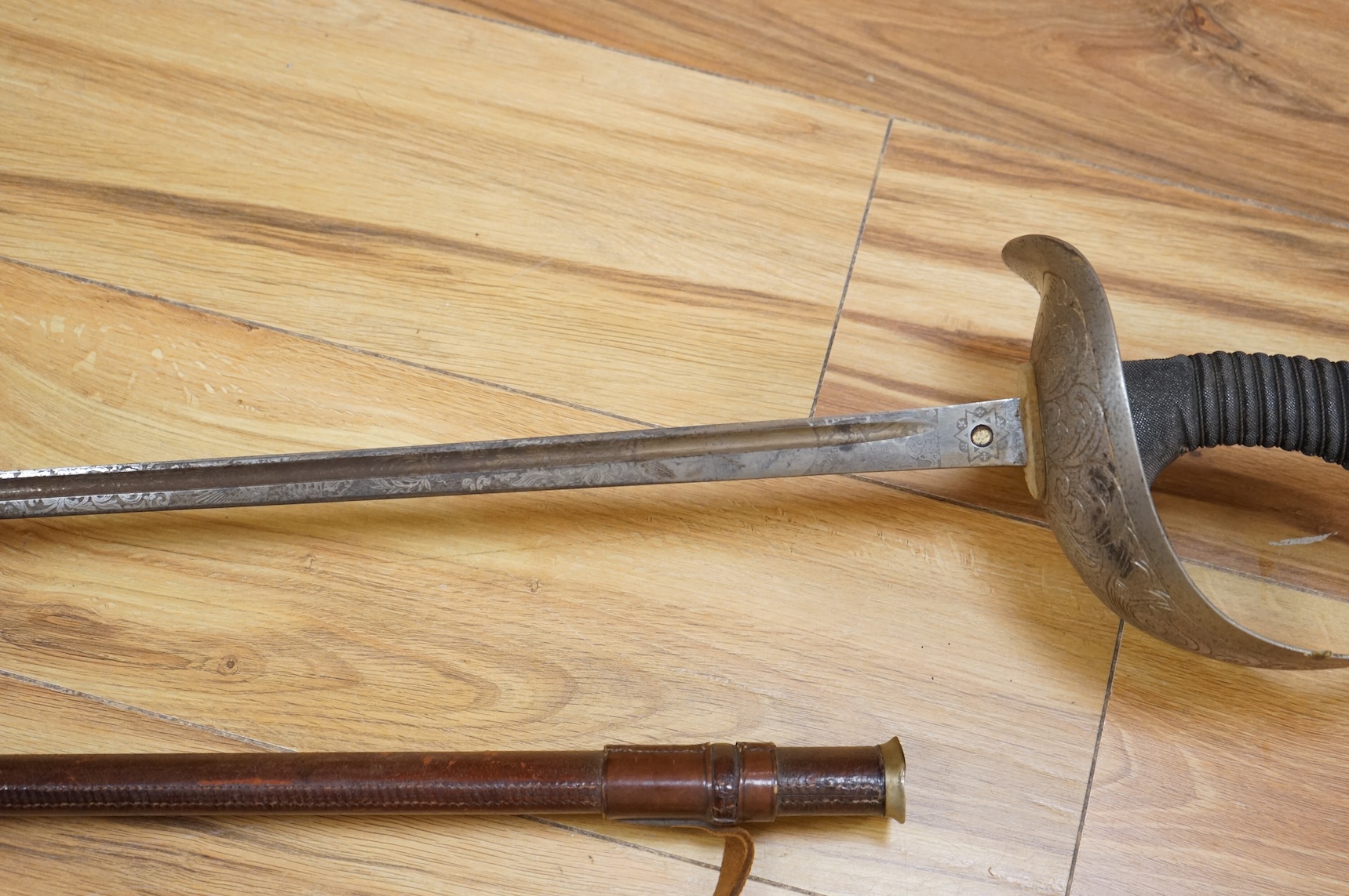 A 1911 pattern cavalry officer’s sword by J. Gaunt and son, etched with crowned GVR cipher and owner’s initials; HPH, regulation hilt and leather covered scabbard